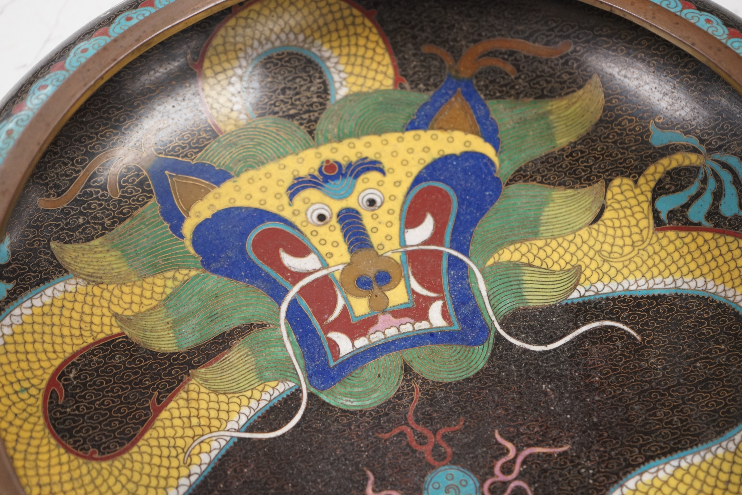 A pair of early 20th century Chinese cloisonné enamel ‘dragon’ bowls, 30cm diameter. Condition - fair to good